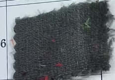 Close-up of a textured gray flannel pet blanket with colorful accents, displayed on a numbered background.