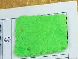 Close-up of a green flannel fabric swatch on a catalog page marked number 45