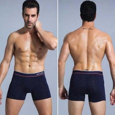 Front and back view of a man modeling plus size navy blue polka-dotted cotton boxer briefs