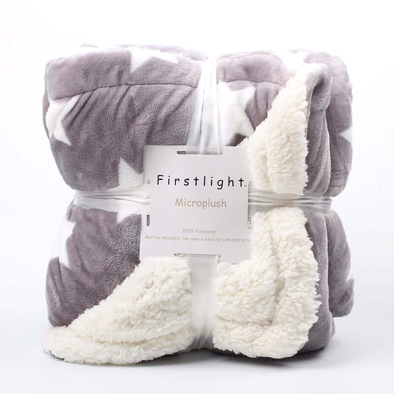 Thick polyester microplush blanket in gray and white, imitation lambskin design, displayed with packaging tag visible