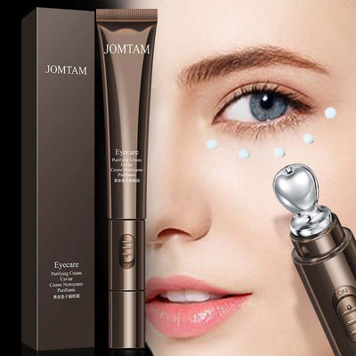 Close-up of woman applying Jomtam eye care cream with stainless steel applicator, alongside product packaging showing eye cream benefits and ingredients.