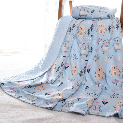 Baby blanket Doudou with 3D hot-pressed bubble design, featuring cute animal patterns, draped over a chair for cozy nursery decor.