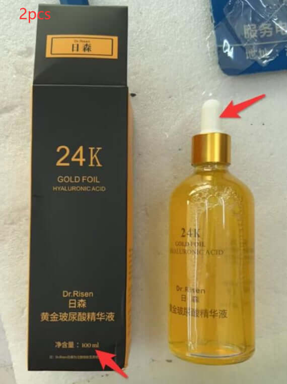 24K Gold Foil Hyaluronic Acid Essence in a transparent bottle next to its packaging box, highlighted with a red arrow pointing to the bottle.