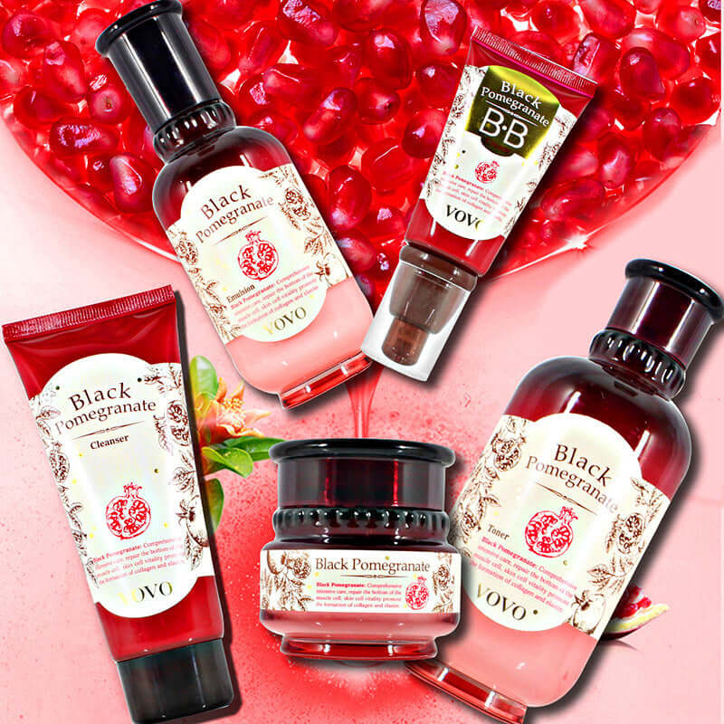 Array of pomegranate skin care products including cleanser, cream, essence, and BB cream on a red pomegranate seed background.