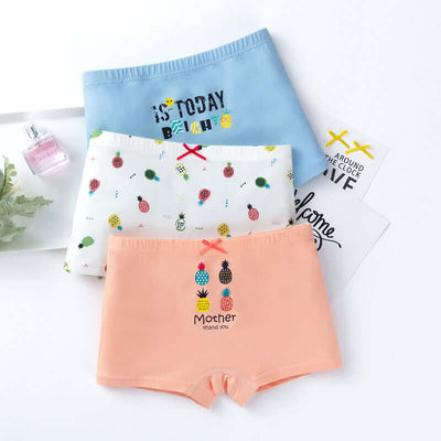 Variety pack of girls' cotton boxer underwear in pastel colors and fun prints, including fruit-themed and slogan designs.